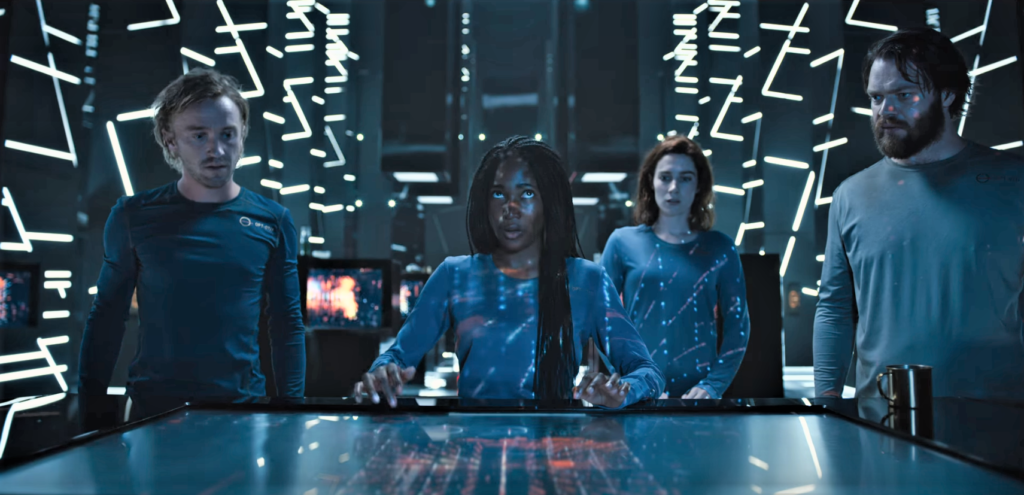 Scene from Season 1, Episode 1 of YouTube's Origin. 4 characters gathered around a computer terminal while one operates it.
